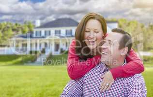 Happy Couple Outdoors In Front of Beautiful House