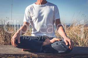 Man sitting in yoga pose.