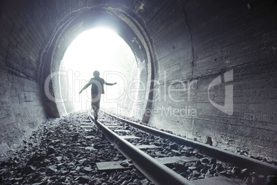 Child walking in railway tunnel