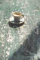 Cup of coffee on wooden table.