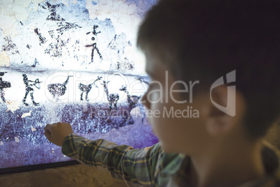 Child looks at aancient mural