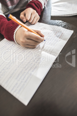 Child write in a notebook.
