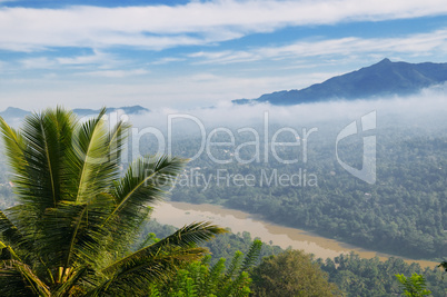 mountain, town and river in the morning mist (top view)