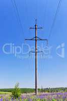High-voltage electric pole with wires on a background of blue sk