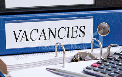 Vacancies - blue binder in the office