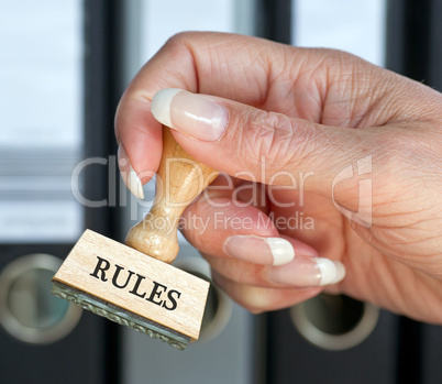 Rules Stamp with hand in the Office