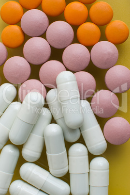 White, pink and orange pills