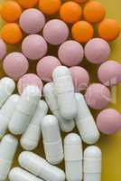 White, pink and orange pills