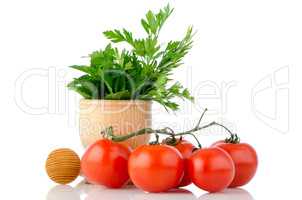 Tomatoes and green herb leafs