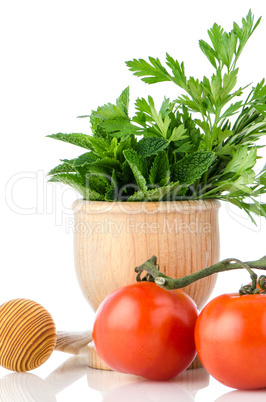 Tomatoes and green herb leafs