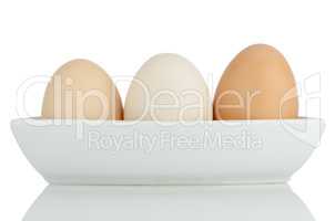 Brown eggs in white ceramic bowl