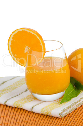 Cup of orange juice and fresh orange