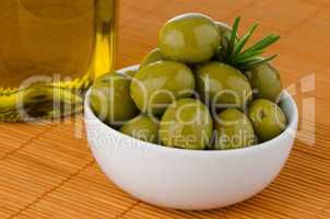 Green olives in a white ceramic bowl