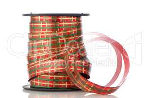 Spool with decorative red ribbon
