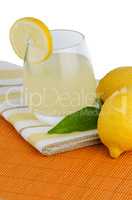 Cup of lemon juice and fresh lemons