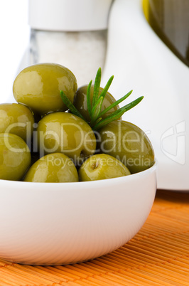 Green olives in a white ceramic bowl