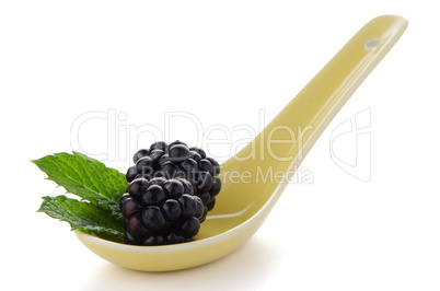 Blackberries in ceramic spoon