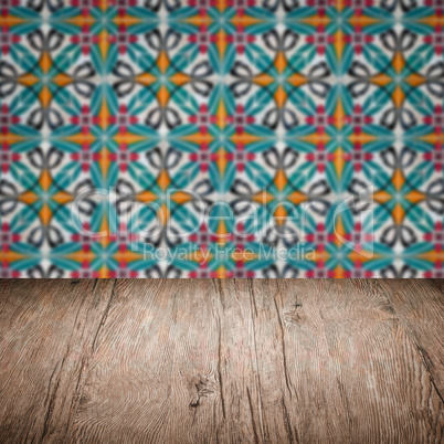 Wood table top and blur vintage ceramic tile pattern wall