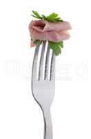Slice of ham skewered on a fork