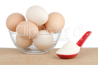 Brown eggs on brown and red ceramic spoon with white powder