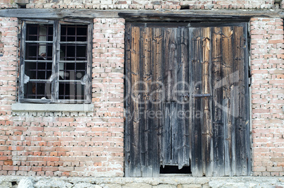 Old wooden gate at brick building