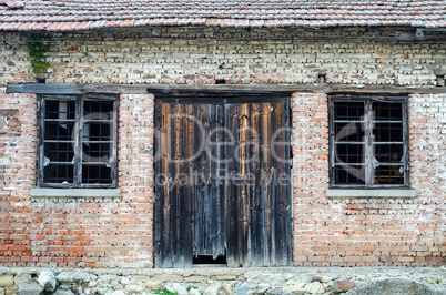 Old wooden gate at brick building