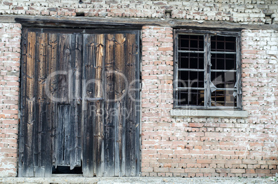 Old wooden gate at brick building