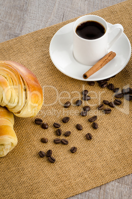 Cup of black coffee and croissant