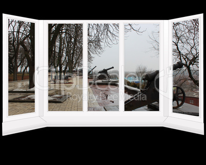 window overlooking the park with ancient cannons