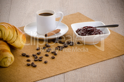 Cup of black coffee and croissant