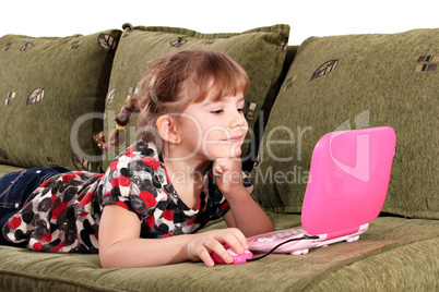 little girl play with laptop