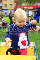 baby plays on the playground