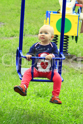 baby plays on the swing