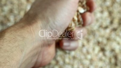 man pours out of the hands of oats