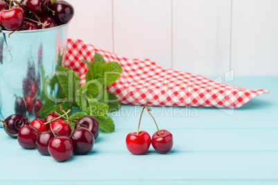 Cherries in two small metal buckets