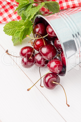 Cherries in small metal bucket