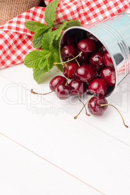 Cherries in small metal bucket