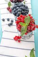 Red currants and blueberries in small metal buckets