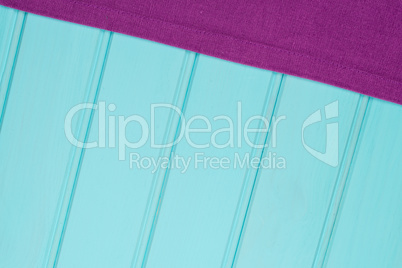 Purple towel over wooden table