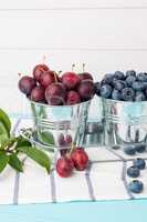 Plums in small metal bucket