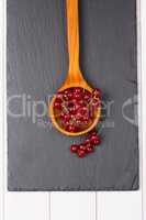 Currants in a wooden spoon