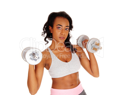 Closeup of exercising girl with dumbbell's.