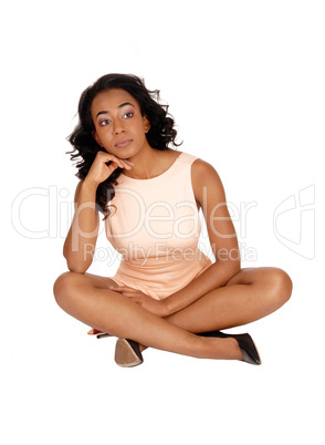 African American woman sitting on floor.