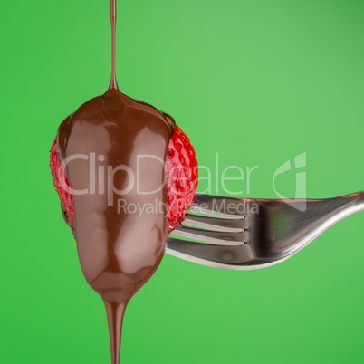 Strawberry and chocolate on a fork