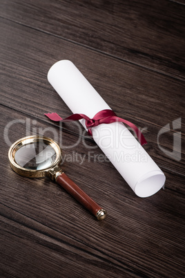 Wrapped paper sheets and magnifying glass