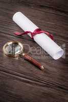 Wrapped paper sheets and magnifying glass