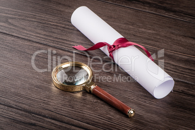 Wrapped paper sheets and magnifying glass