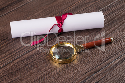 Wrapped paper sheets and magnifying glass