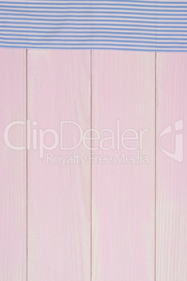 White and blue towel over wooden table