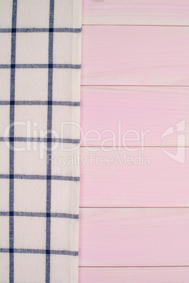 White and blue towel over wooden table